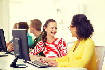 Image showing smiling students in computer class at school