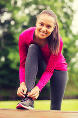 Image showing smiling woman exercising outdoors