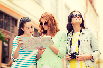 Image showing teenage girls with map and camera