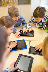 Image showing group of school kids with tablet pc in classroom