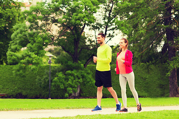 Image showing smiling couple running outdoors