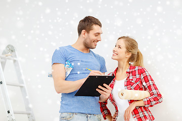 Image showing smiling couple with clipboard and wallpaper roll