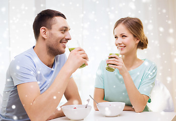 Image showing smiling couple having breakfast at home