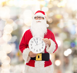 Image showing man in costume of santa claus with clock