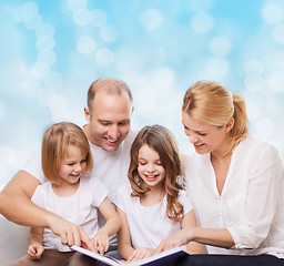 Image showing happy family with book at home