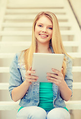 Image showing smiling female student with tablet pc computer