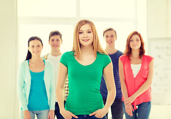 Image showing smiling students with teenage girl in front