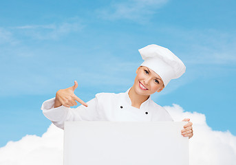 Image showing smiling female chef with white blank board