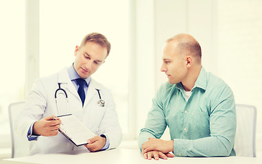 Image showing doctor with clipboard and patient in hospital