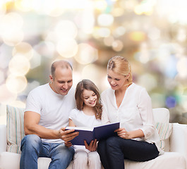 Image showing happy family with book at home