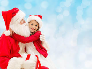 Image showing smiling little girl with santa claus