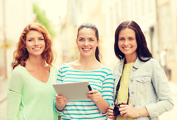 Image showing smiling teenage girls with tablet pc and camera