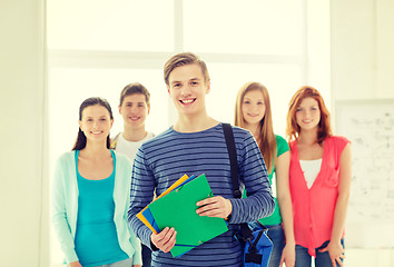 Image showing smiling students with teenage boy in front