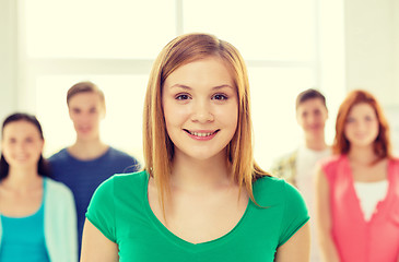 Image showing smiling students with teenage girl in front