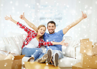 Image showing smiling couple relaxing on sofa in new home