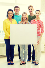 Image showing smiling students with white blank board at school