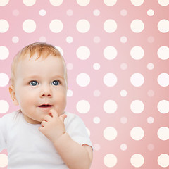 Image showing smiling baby girl face over pink polka dots