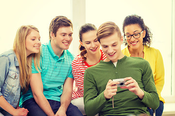 Image showing smiling students with digital camera at school