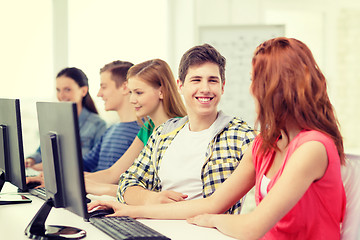 Image showing smiling students in computer class at school