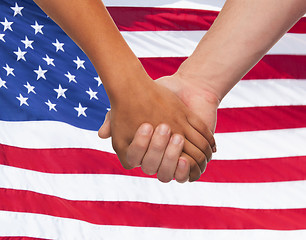 Image showing close up of hands holding over american flag