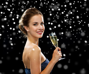 Image showing smiling woman holding glass of sparkling wine