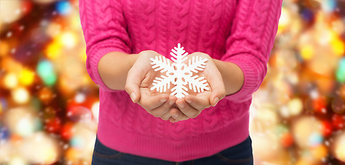Image showing close up of woman holding snowflake decoration