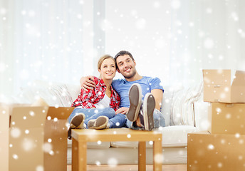 Image showing smiling couple relaxing on sofa in new home