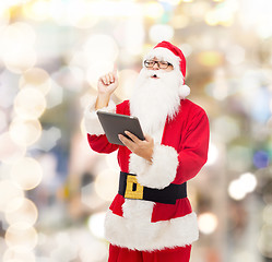 Image showing man in costume of santa claus with tablet pc