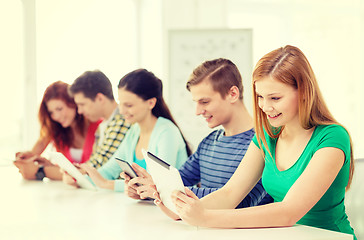 Image showing smiling students with tablet pc at school