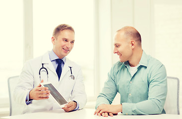 Image showing doctor with tablet pc and patient in hospital