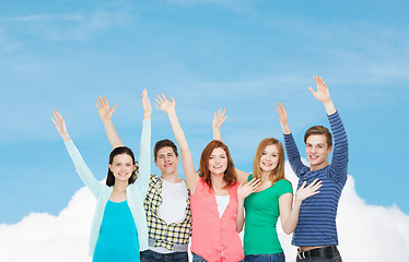 Image showing group of smiling students waving hands