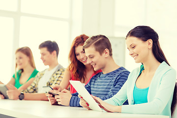 Image showing smiling students with tablet pc at school