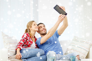 Image showing smiling couple with tablet pc computer at home