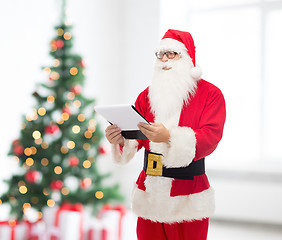 Image showing man in costume of santa claus with notepad