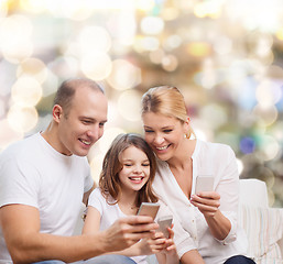 Image showing happy family with smartphones