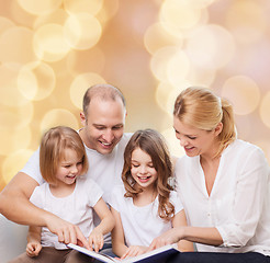 Image showing happy family with book at home