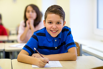 Image showing group of school kids writing test in classroom