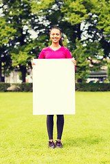 Image showing smiling teenage girl with blank white board