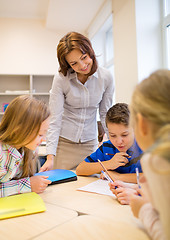 Image showing group of school kids writing test in classroom