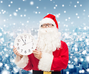 Image showing man in costume of santa claus with clock