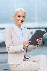 Image showing smiling businesswoman with tablet pc outdoors