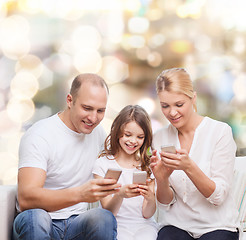 Image showing happy family with smartphones