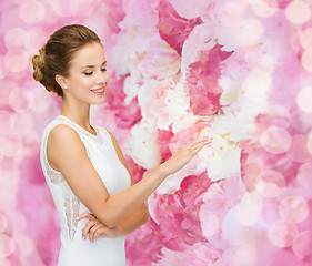 Image showing smiling woman in white dress with diamond ring