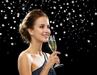 Image showing smiling woman holding glass of sparkling wine