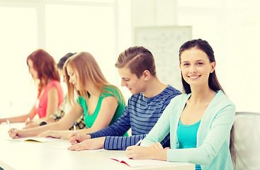 Image showing smiling students with textbooks at school