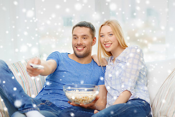 Image showing smiling couple watching tv at home