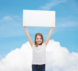Image showing smiling little girl holding blank white board