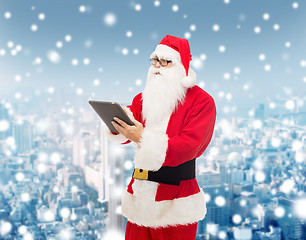 Image showing man in costume of santa claus with tablet pc