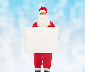 Image showing man in costume of santa claus with billboard