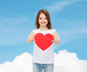 Image showing beautiful little girl sitting at table